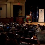 Speaker stands on stage